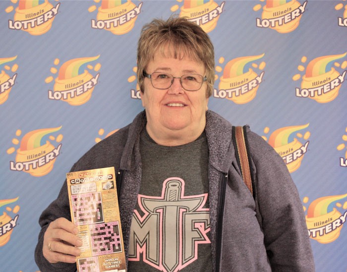 Vickie Weikle holds her winning $250,000 Crossword ticket.